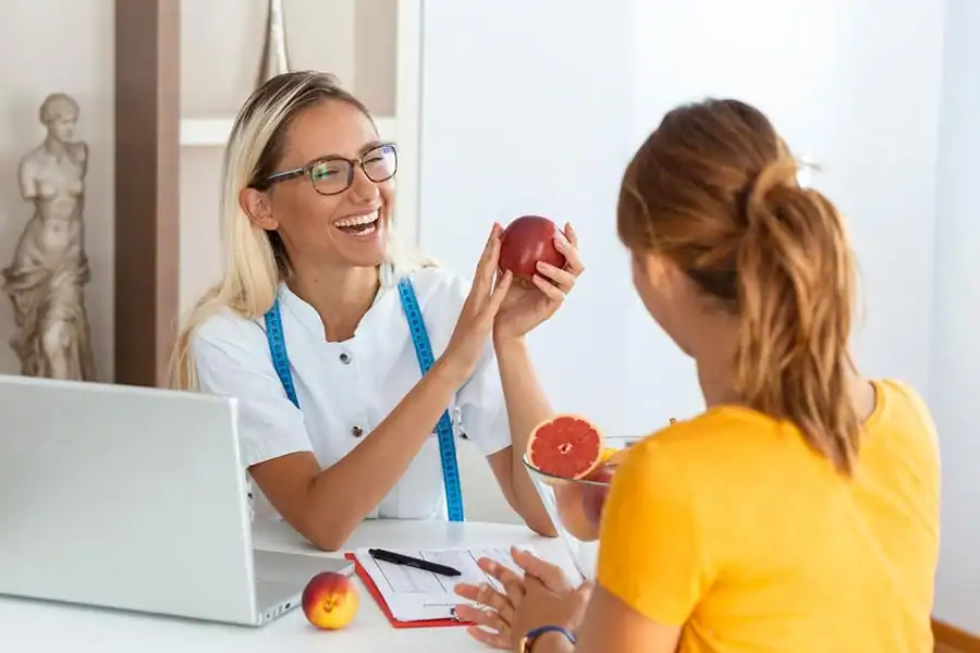 female-nutritionist-giving-consultation-to-patient-making-diet-plan-in-weight-loss-clinic-Weight-Loss-Miami